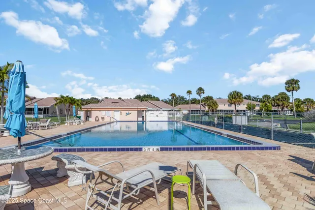 a view of a swimming pool with an outdoor seating