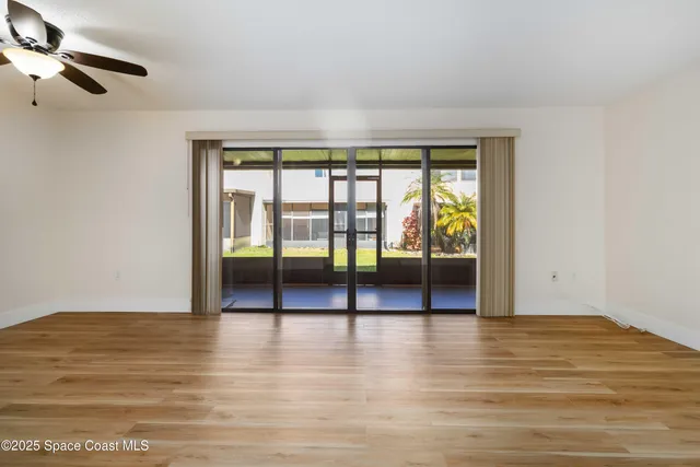 a view of an empty room with glass door