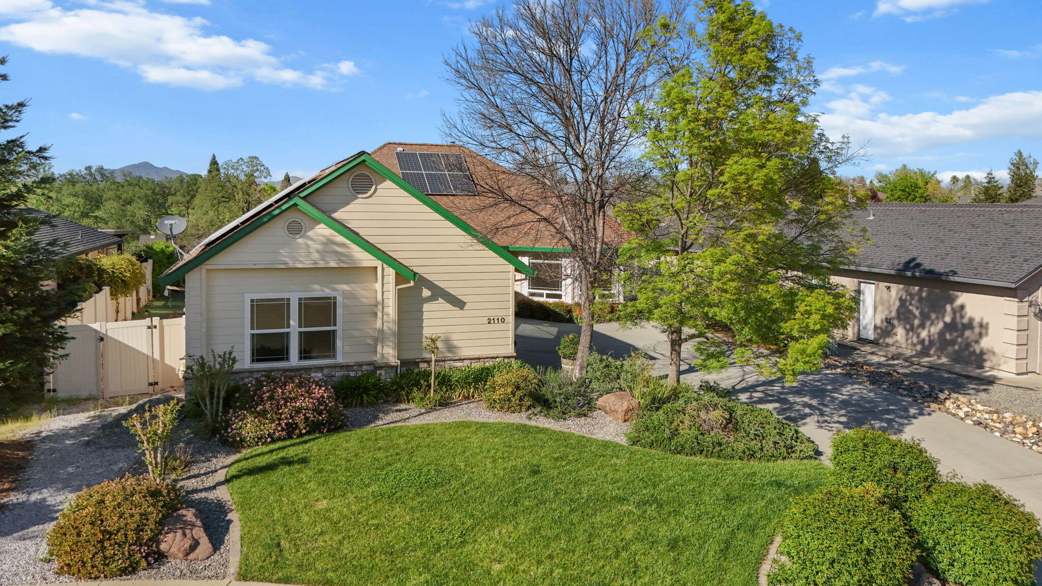 2110 Cadjew Street Redding, CA 96003 - Photo 58 of 62 a view of a house with a yard and potted plants
