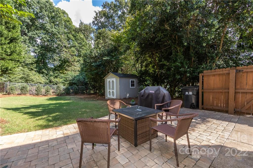 6409 Montpelier Road Charlotte, NC 28210 - Photo 30 of 35 a view of a chair and table in backyard of the house