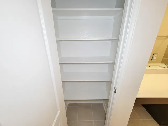 an empty room with wooden floor and window