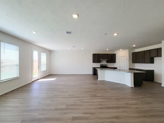 a kitchen with stainless steel appliances granite countertop a sink stove and cabinets