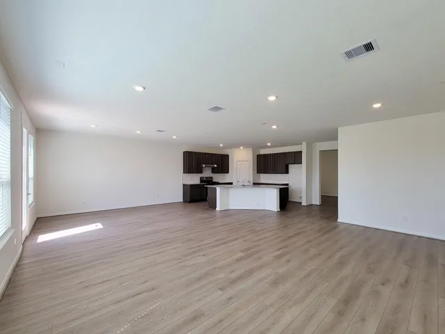 a kitchen with stainless steel appliances granite countertop a stove top oven a sink and a refrigerator