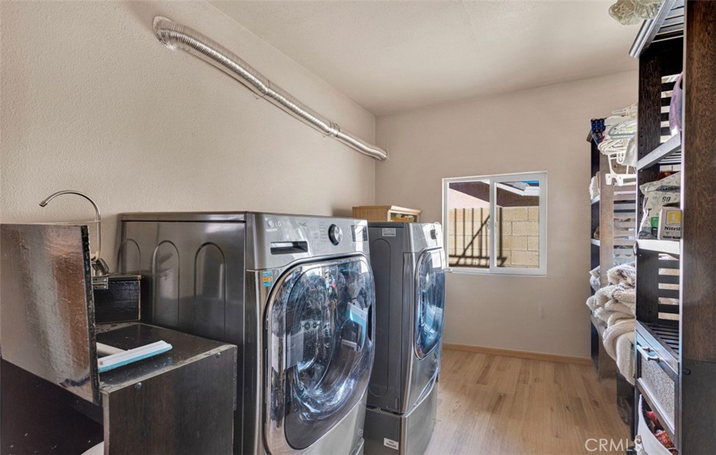18199 Kalin Ranch Drive Victorville, CA 92395 - Photo 12 of 31 a view of water heater room with washer and dryer