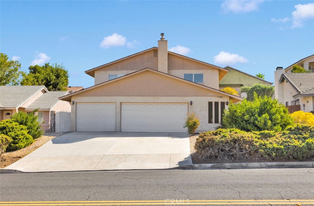 18199 Kalin Ranch Drive Victorville, CA 92395 - Photo 2 of 31 a front view of a house with a yard and garage