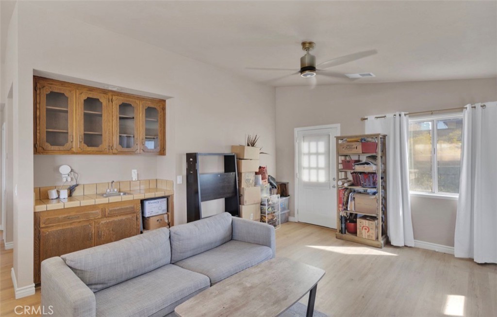 18199 Kalin Ranch Drive Victorville, CA 92395 - Photo 5 of 31 a living room with furniture and a walk in closet