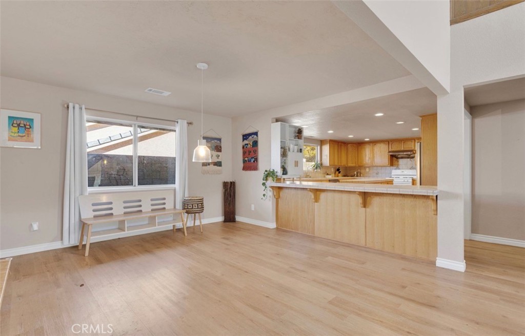 18199 Kalin Ranch Drive Victorville, CA 92395 - Photo 6 of 31 a view of kitchen with cabinets and wooden floor