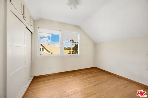 a view of a room with wooden floor