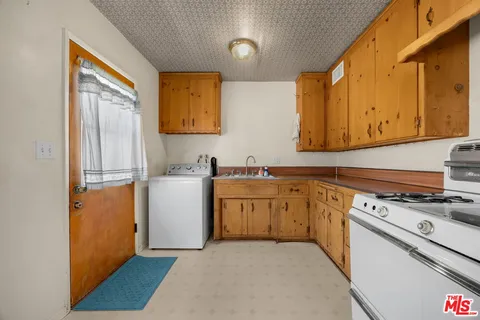 a kitchen with a stove a sink and a refrigerator