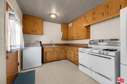 a kitchen with a stove a sink and a refrigerator