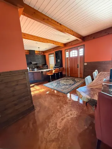 a view of a patio with table and chairs with wooden floor and fence