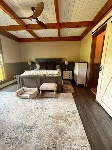 a front view of house with yard and trees in the background