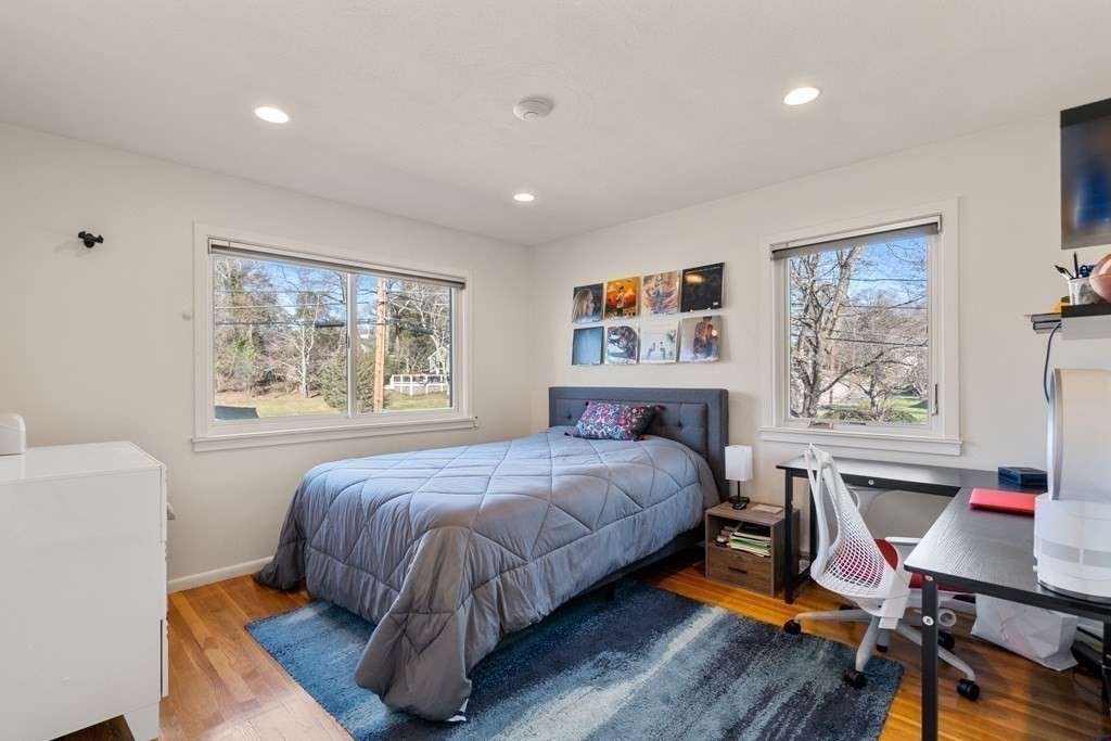 27 Grace Road Newton, MA 02459 - Photo 13 of 26 a bedroom with a large bed a desk and chair next to a window