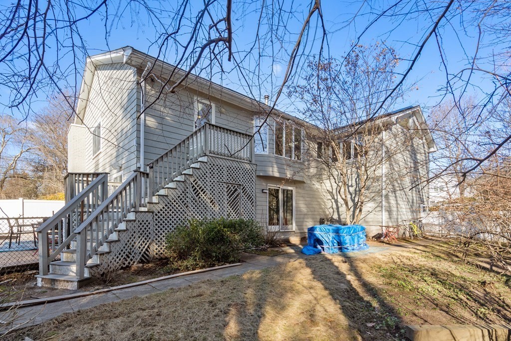 27 Grace Road Newton, MA 02459 - Photo 25 of 26 a view of a house with large trees next to a road