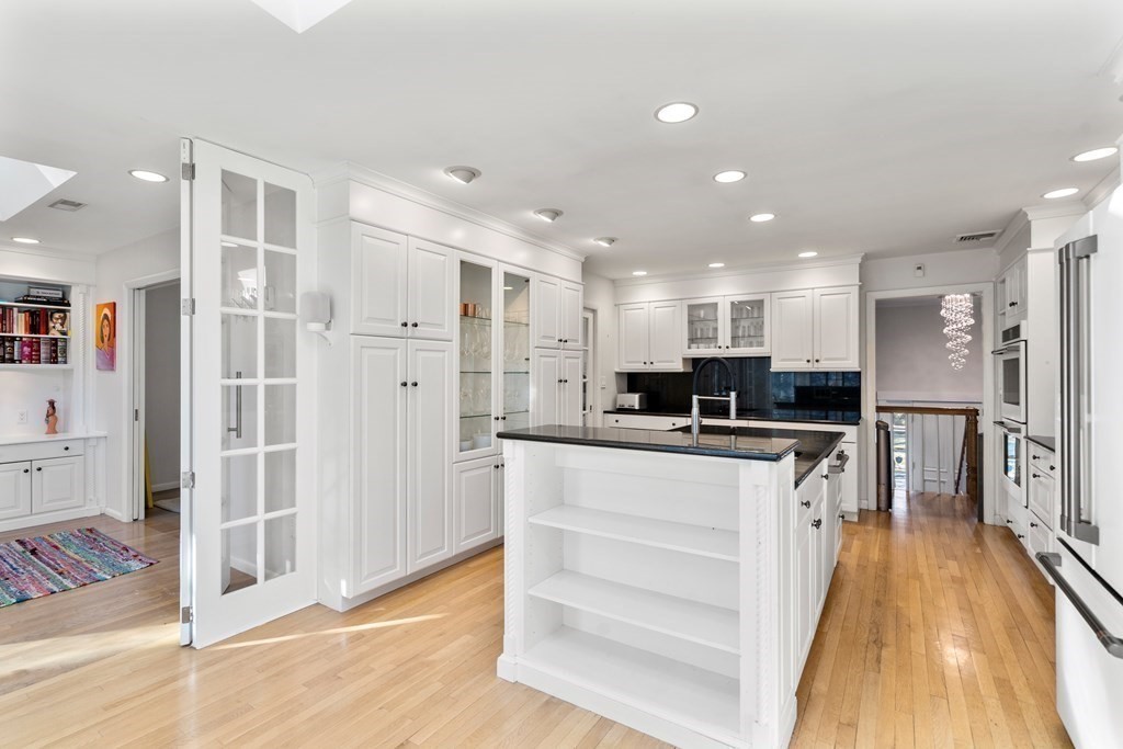 27 Grace Road Newton, MA 02459 - Photo 7 of 26 a large white kitchen with white cabinets and stainless steel appliances
