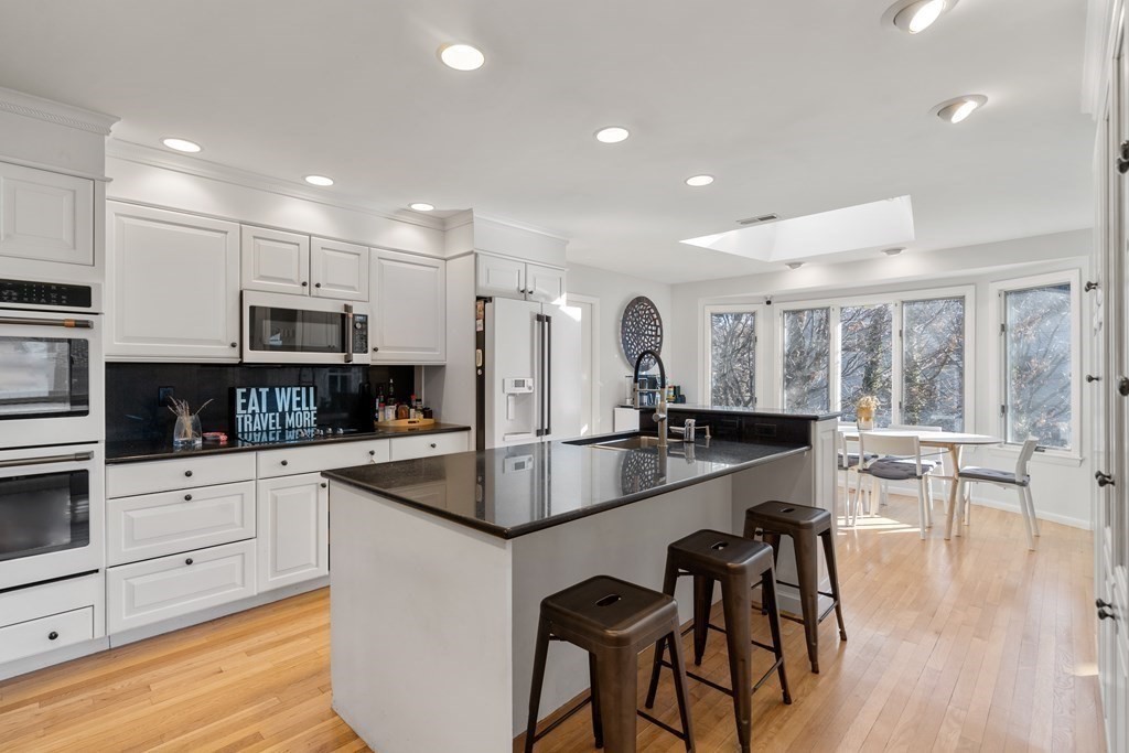 27 Grace Road Newton, MA 02459 - Photo 9 of 26 a large kitchen with granite countertop lots of counter space and furniture