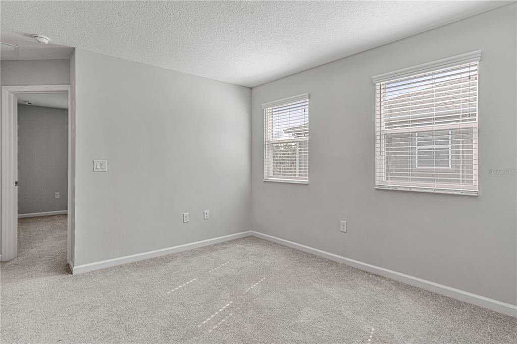2875 Narcoossee Cmns Way St. Cloud, FL 34771 - Photo 18 of 50 an empty room with windows
