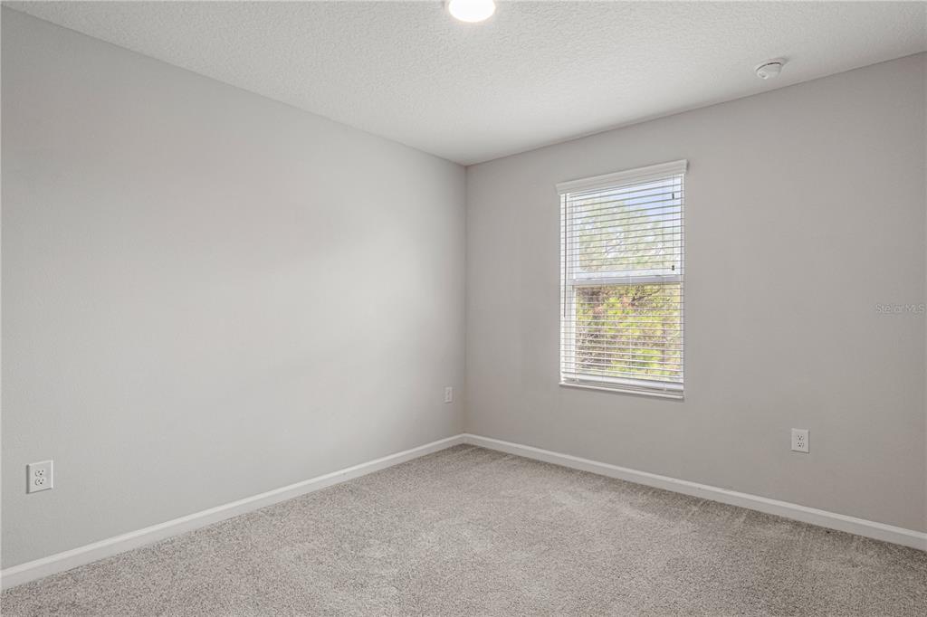 2875 Narcoossee Cmns Way St. Cloud, FL 34771 - Photo 22 of 50 an empty room with a window