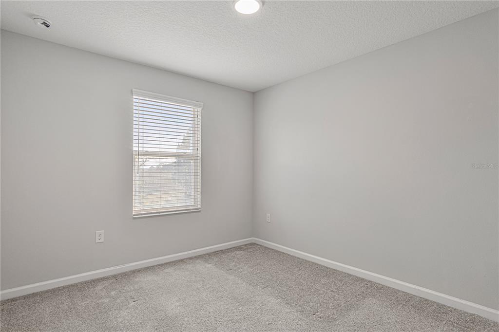 2875 Narcoossee Cmns Way St. Cloud, FL 34771 - Photo 24 of 50 an empty room with a window