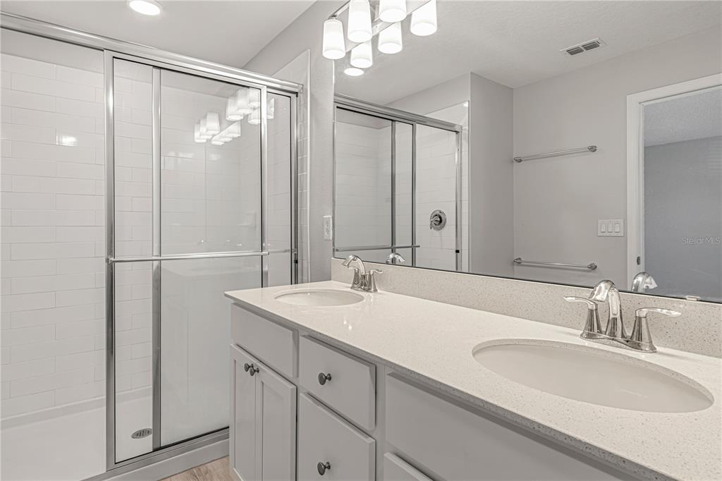 2875 Narcoossee Cmns Way St. Cloud, FL 34771 - Photo 32 of 50 a bathroom with a sink and a mirror