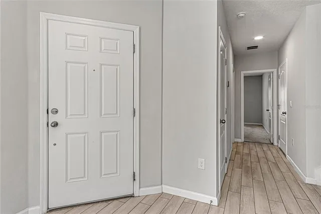 a view of a hallway with wooden floor