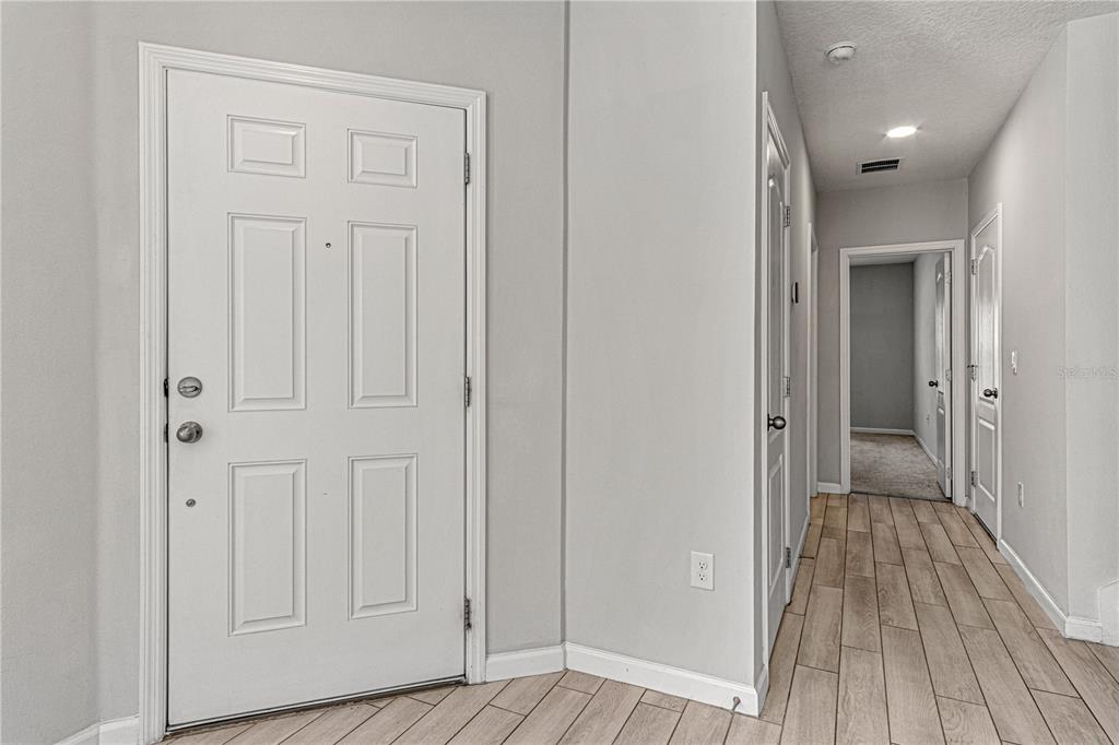 2875 Narcoossee Cmns Way St. Cloud, FL 34771 - Photo 4 of 50 a view of a hallway with wooden floor