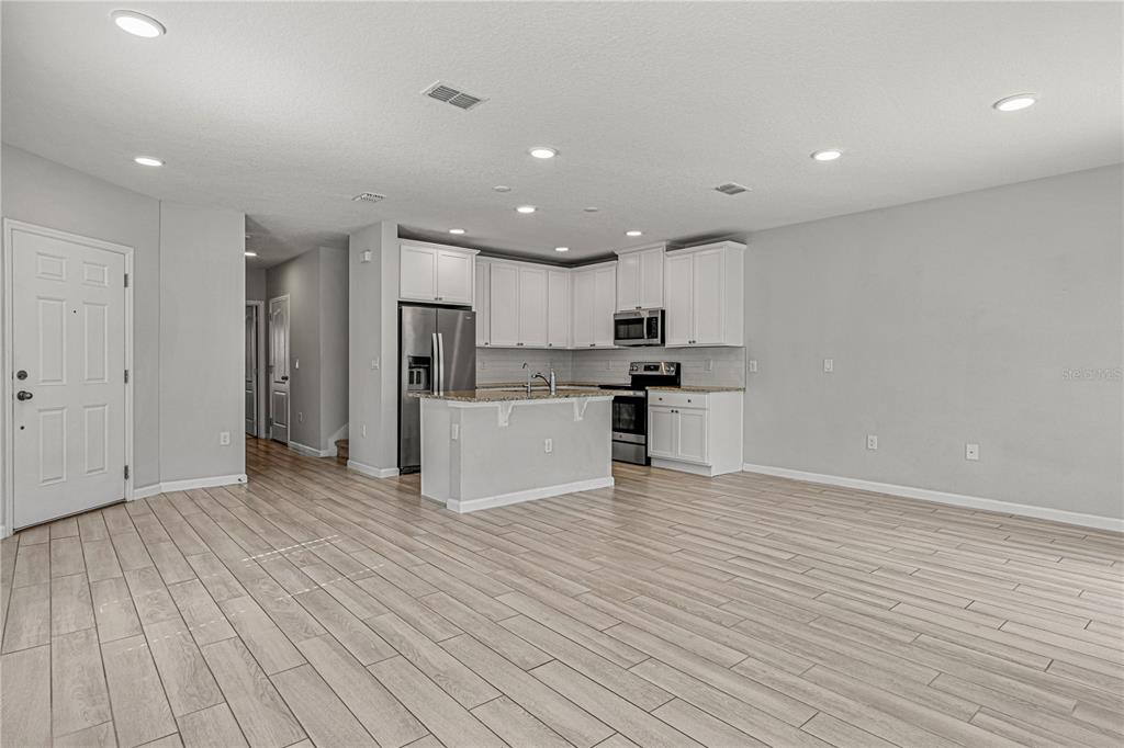 2875 Narcoossee Cmns Way St. Cloud, FL 34771 - Photo 6 of 50 a view of kitchen with wooden floor