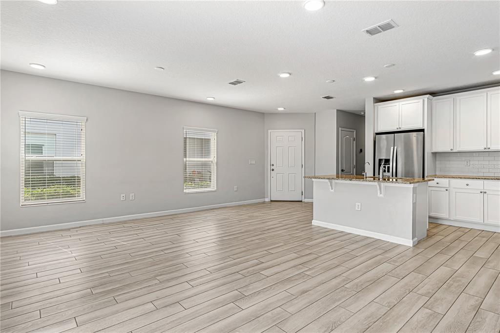 2875 Narcoossee Cmns Way St. Cloud, FL 34771 - Photo 7 of 50 a view of kitchen with kitchen island wooden floor center island and stainless steel appliances