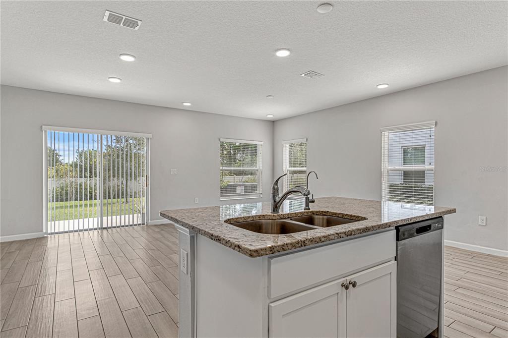 2875 Narcoossee Cmns Way St. Cloud, FL 34771 - Photo 8 of 50 a kitchen with a sink and wooden floor