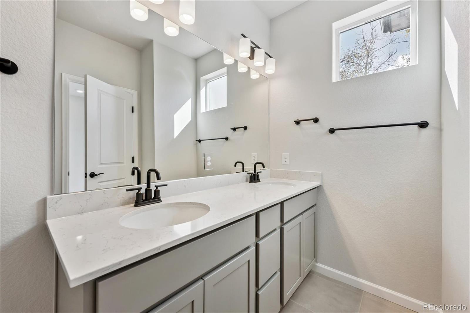451 Interlocken Boulevard, Unit 101 Broomfield, CO 80021 - Photo 11 of 17 a bathroom with a sink double vanity and a mirror
