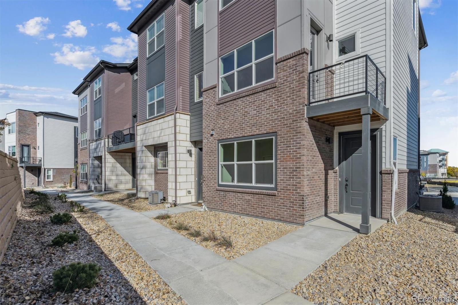 451 Interlocken Boulevard, Unit 101 Broomfield, CO 80021 - Photo 17 of 17 a view of a brick house with many windows