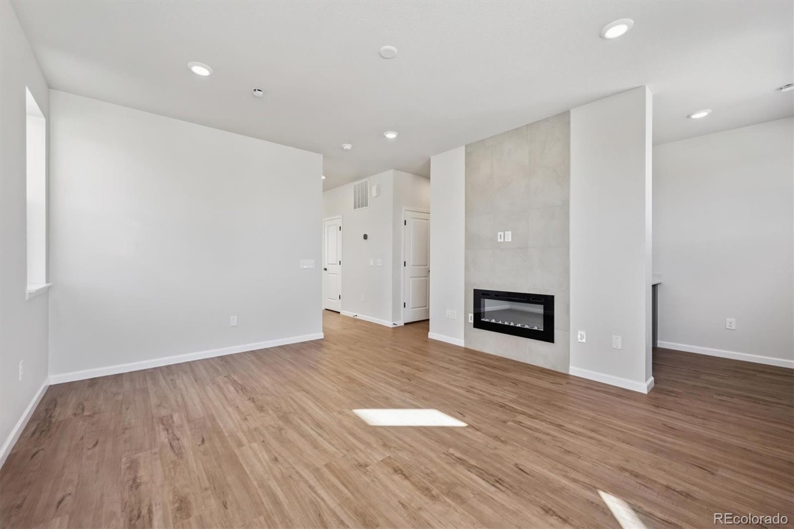 451 Interlocken Boulevard, Unit 101 Broomfield, CO 80021 - Photo 4 of 17 a view of a hallway with wooden floor