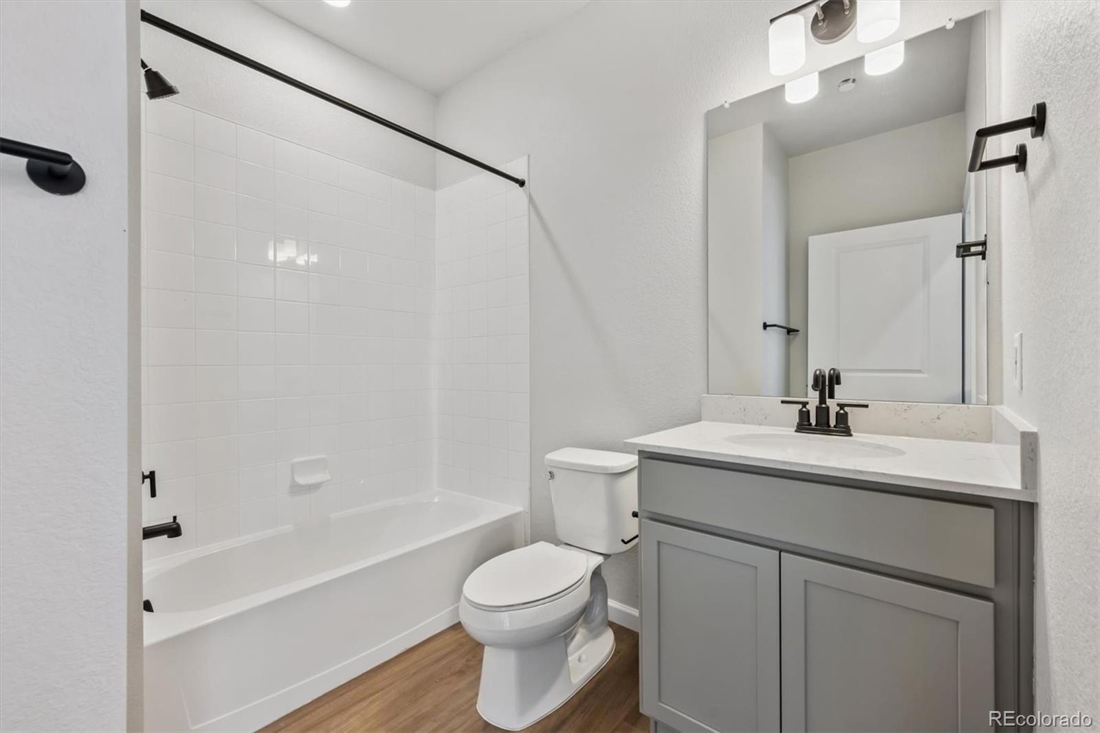 451 Interlocken Boulevard, Unit 101 Broomfield, CO 80021 - Photo 7 of 17 a bathroom with a sink toilet vanity and shower