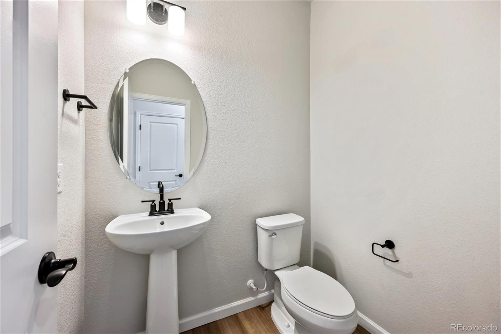 451 Interlocken Boulevard, Unit 101 Broomfield, CO 80021 - Photo 8 of 17 a bathroom with a toilet sink and mirror