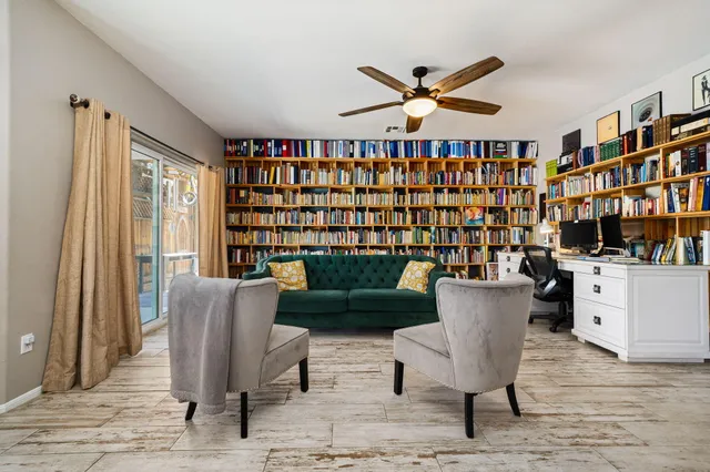 a work room with furniture and a book shelf