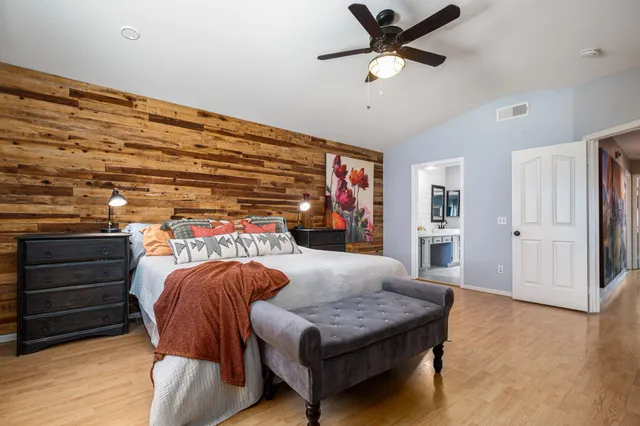 a living room with furniture and a ceiling fan