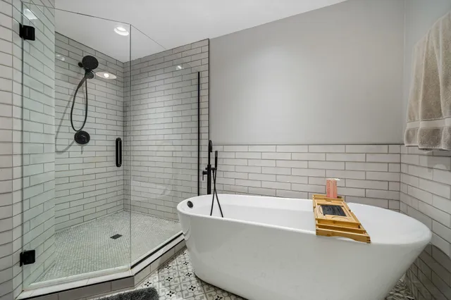 a bathroom with a bath tub and shower