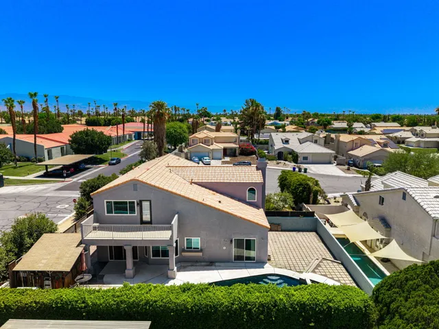 an aerial view of a house with a yard and lake view