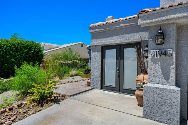 front view of a house with potted plants