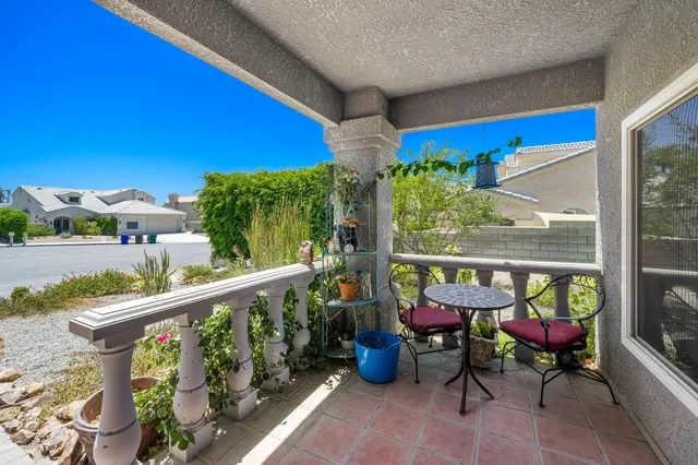 a view of a chairs and table in patio with wooden fence