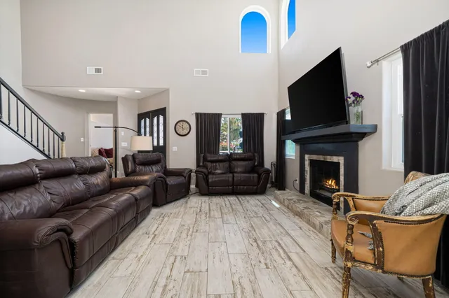 a living room with furniture a flat screen tv and a fireplace