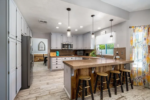 a large kitchen with a table and chairs