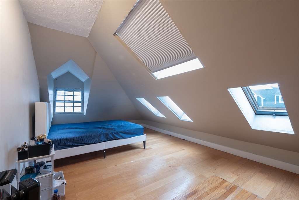 11 Wayne Street Boston, MA 02121 - Photo 26 of 27 a view of bedroom with a bed and wooden floor