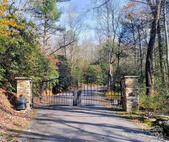 a view of a balcony with a floor to ceiling window and wooden fence
