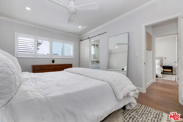 a spacious bedroom with a bed and a walk in closet