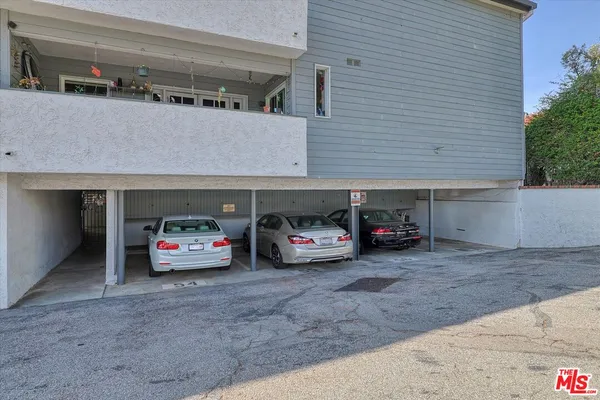 a view of a car parked front of garage