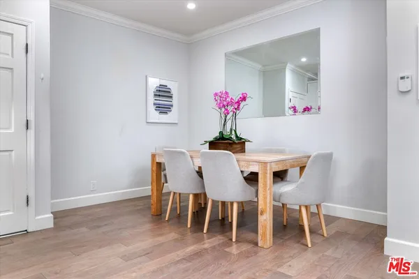 a dining room with furniture and wooden floor