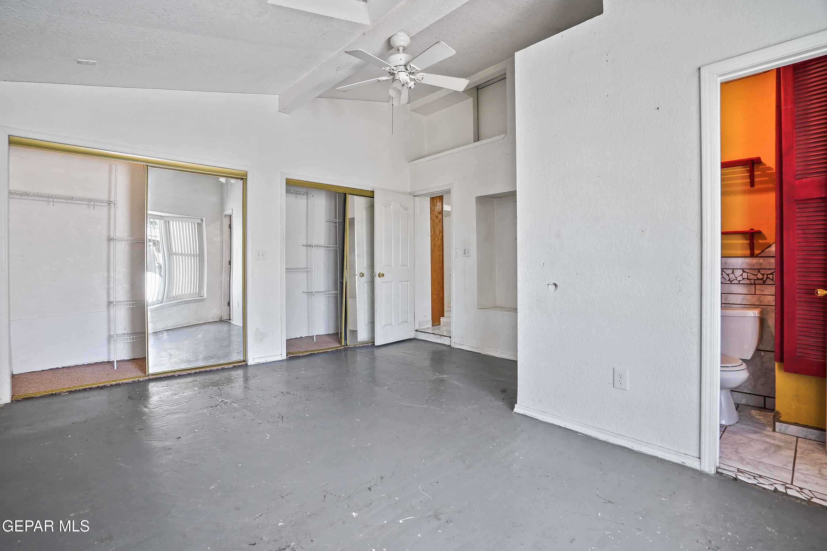 306 A Street Southwest Fabens, TX 79838 - Photo 18 of 37 an empty room with chandelier fan and windows