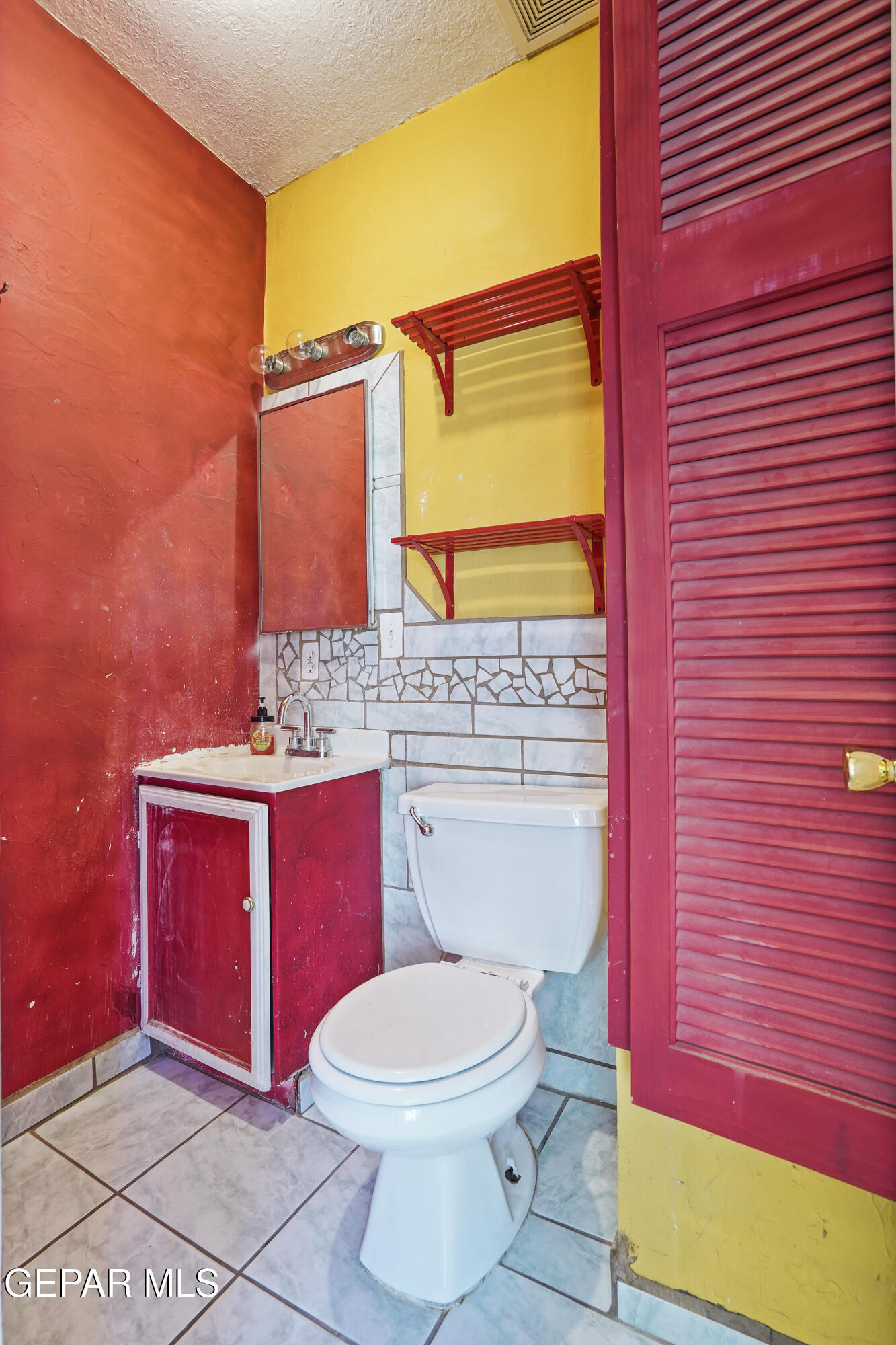 306 A Street Southwest Fabens, TX 79838 - Photo 19 of 37 a bathroom with a toilet a sink and mirror
