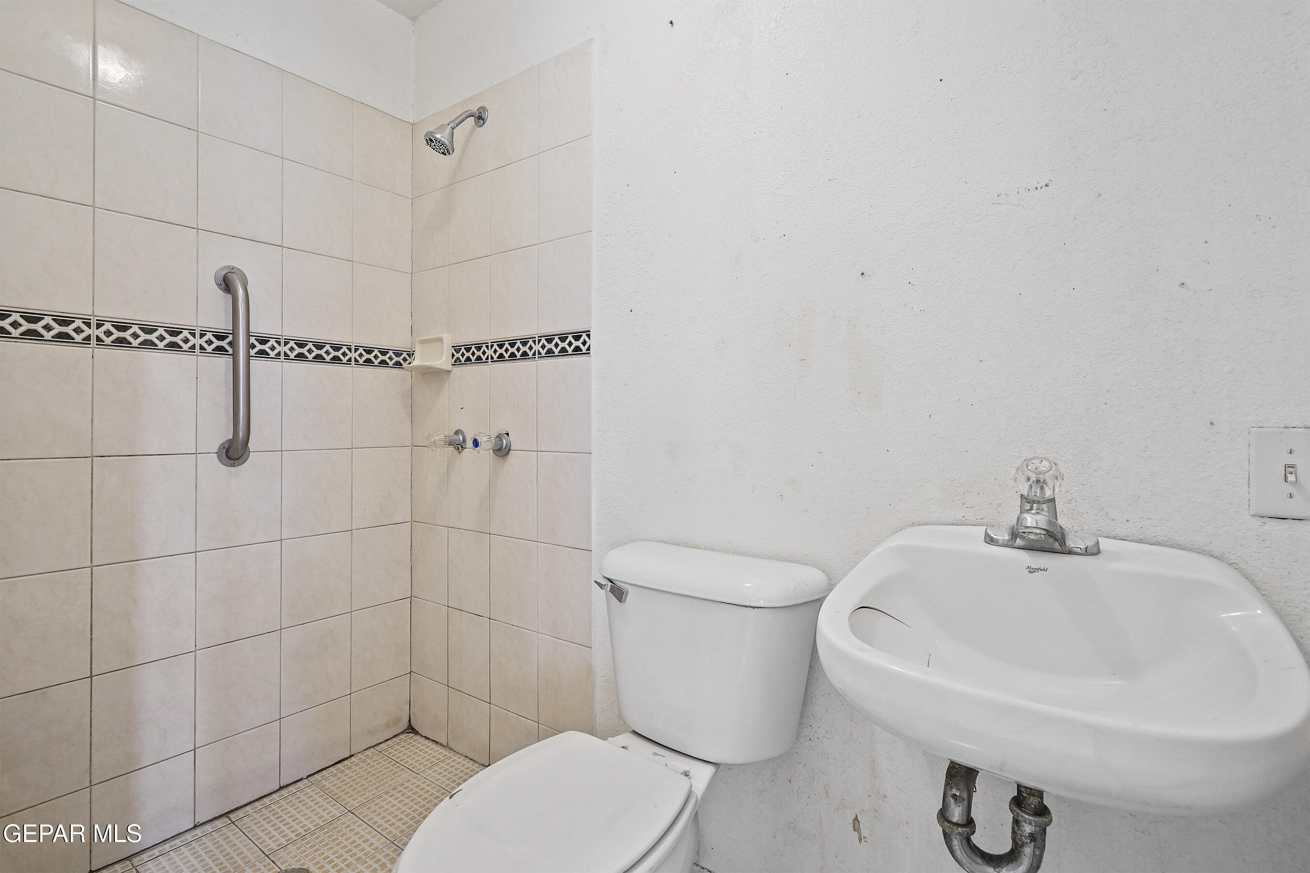 306 A Street Southwest Fabens, TX 79838 - Photo 20 of 37 a white toilet sitting next to a bathroom sink